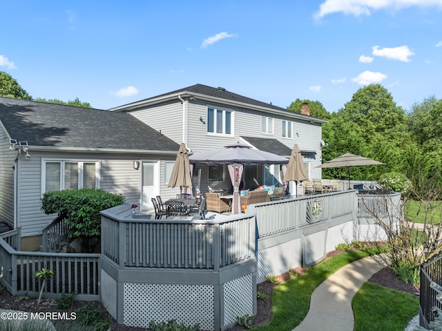 19 Dartmoor Dr, Manalapan, NJ 07726 - back of house with a gazebo, a deck, outdoor dining area, a shingled roof, and an outdoor living space