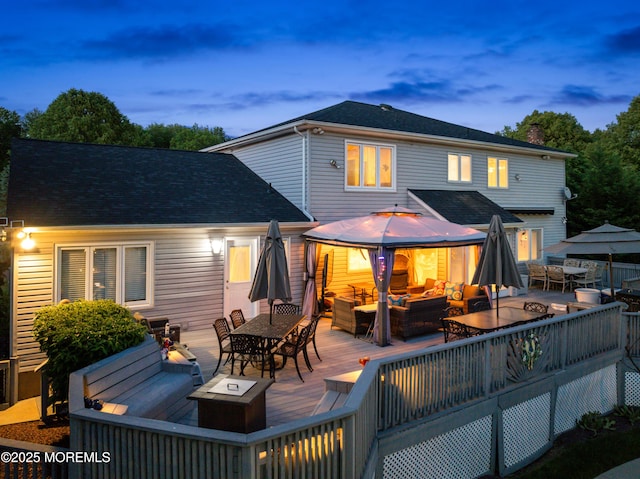 19 Dartmoor Dr, Manalapan, NJ 07726 - back of house with an outdoor living space with a fire pit, outdoor dining space, a wooden deck, a gazebo, and a chimney