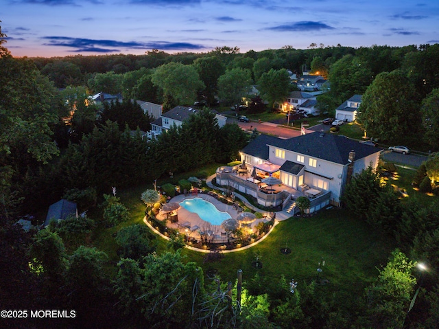 19 Dartmoor Dr, Manalapan, NJ 07726 - aerial view at dusk of view of pool area and a view of trees