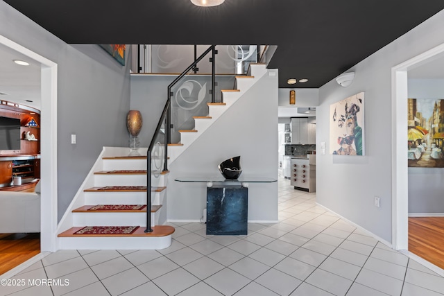 19 Dartmoor Dr, Manalapan, NJ 07726 - staircase with tile patterned flooring and baseboards
