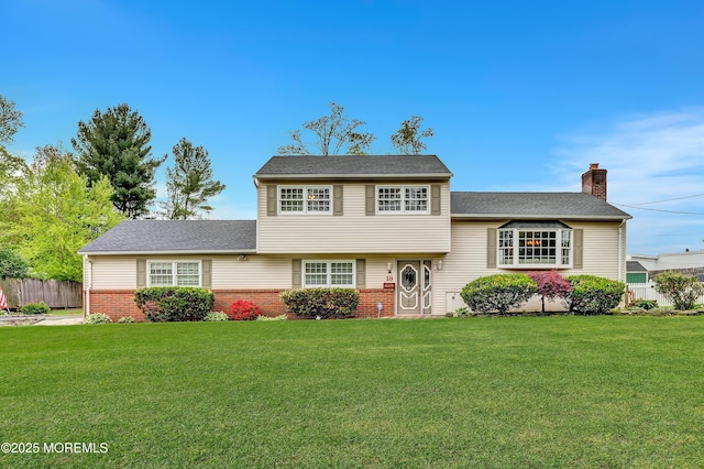 split level home with a chimney and brick siding
