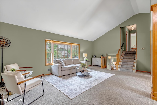 carpeted living area featuring vaulted ceiling, stairs, and baseboards