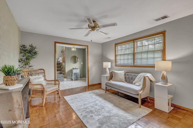sitting room with baseboards and ceiling fan
