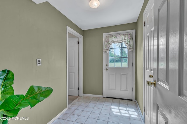 doorway to outside with baseboards and light tile patterned floors