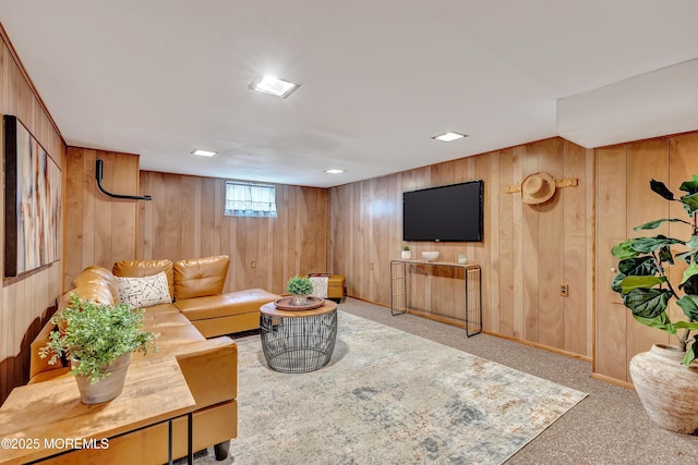 living room with carpet and wood walls