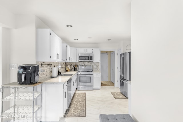 1 Skylark Dr, Jackson, NJ 08527 - kitchen with appliances with stainless steel finishes, light countertops, decorative backsplash, white cabinets, and recessed lighting