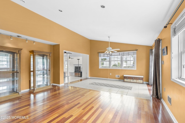 1 Skylark Dr, Jackson, NJ 08527 - unfurnished living room featuring a ceiling fan, wood-type flooring, lofted ceiling, and rail lighting