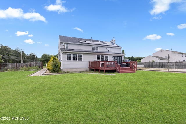 1 Skylark Dr, Jackson, NJ 08527 - back of property featuring a deck, a fenced backyard, and solar panels