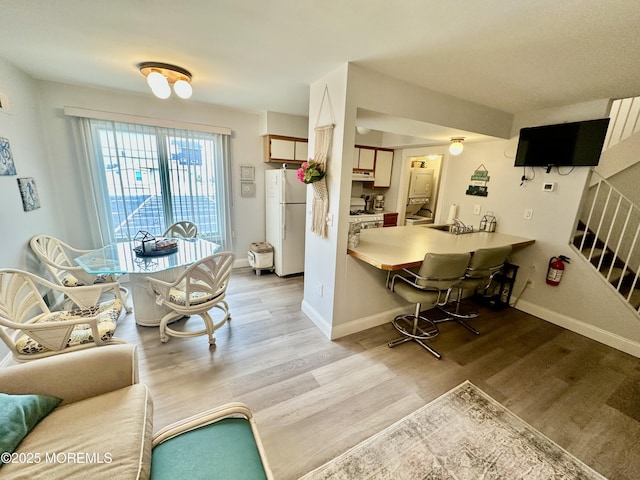 1709 N Rte 35 N Unit 12, Ortley Beach, NJ 08751 - dining space with stairway, light wood finished floors, and baseboards