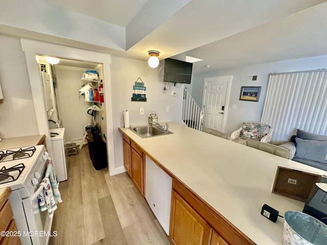 1709 N Rte 35 N Unit 12, Ortley Beach, NJ 08751 - kitchen with light wood-style flooring, a sink, brown cabinets, light countertops, and white range with gas cooktop
