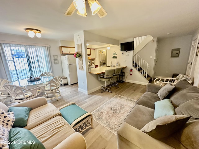 1709 N Rte 35 N Unit 12, Ortley Beach, NJ 08751 - living area featuring baseboards, ceiling fan, stairs, electric panel, and light wood-style floors