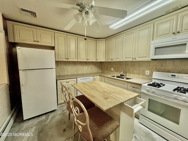 kitchen featuring white appliances, a sink, cream cabinetry, a ceiling fan, and wood counters