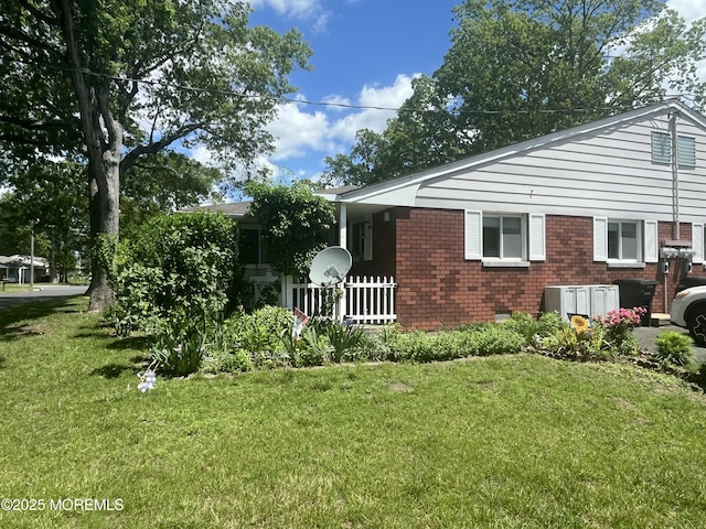 8 Lark St Unit A, Manchester, NJ 08759 - view of home's exterior with a lawn and brick siding
