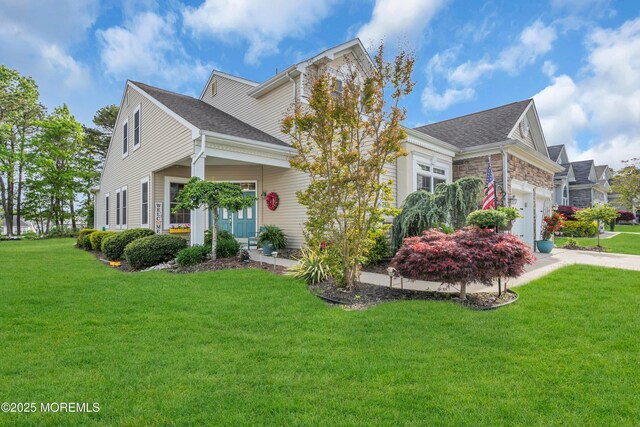 16 Millstone Way, Waretown, NJ 08758 - view of front facade featuring a front lawn, an attached garage, a shingled roof, and driveway