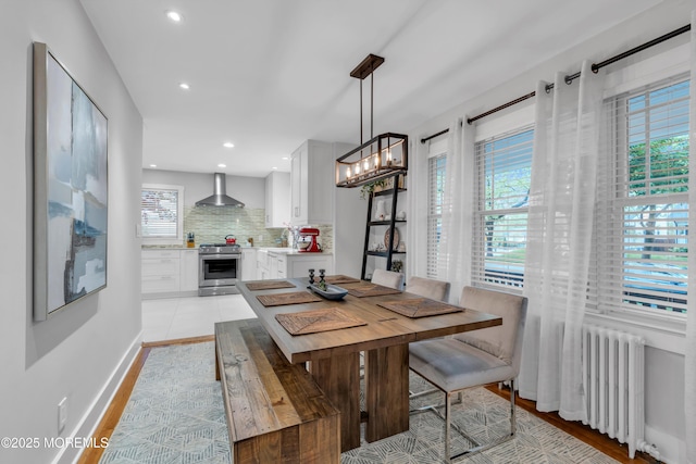 dining room with radiator, plenty of natural light, a chandelier, and recessed lighting