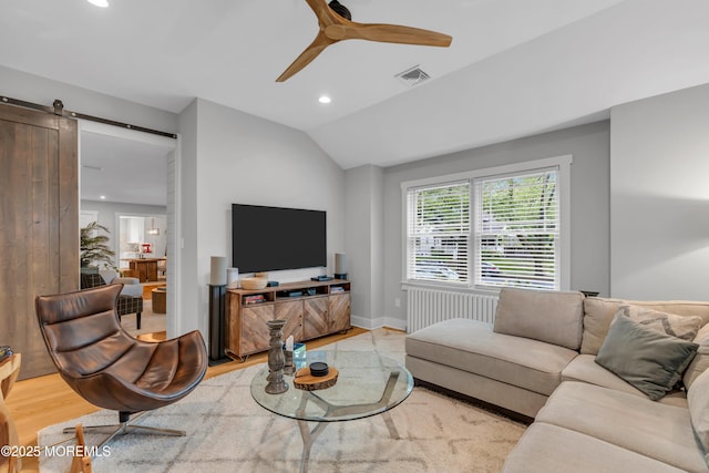 living room featuring a barn door, recessed lighting, vaulted ceiling, ceiling fan, and radiator