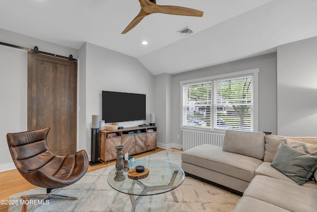 living area featuring radiator, a barn door, baseboards, recessed lighting, and vaulted ceiling