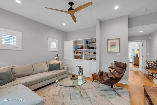 living area with light wood finished floors, ceiling fan, recessed lighting, and baseboards