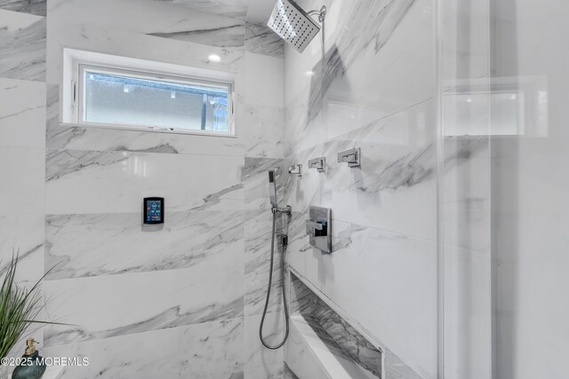 full bath featuring a marble finish shower