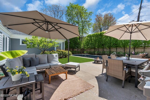 view of patio / terrace with an outdoor living space with a fire pit, outdoor dining area, and a fenced backyard