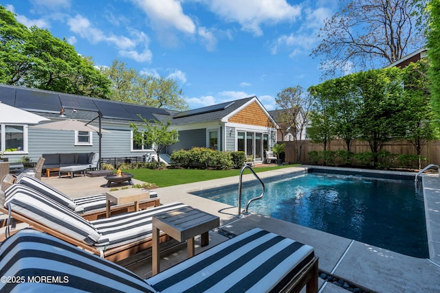 view of pool with an outdoor living space with a fire pit, a patio, and a fenced backyard