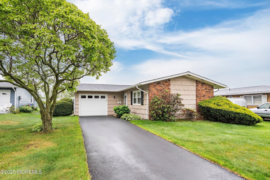 124 Blake Cir, Brick, NJ 08724 - ranch-style home with a garage, driveway, and a front lawn