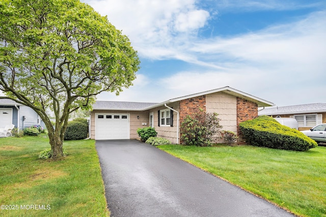 ranch-style home with a garage, driveway, and a front lawn