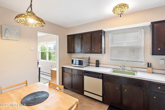 kitchen with white dishwasher, stainless steel microwave, a sink, light countertops, and dark brown cabinets