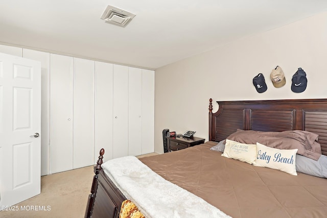 bedroom with light colored carpet and a closet