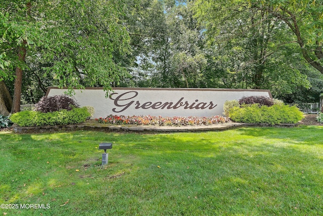 community / neighborhood sign with a yard