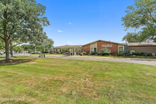 view of front of home with brick siding and a front lawn