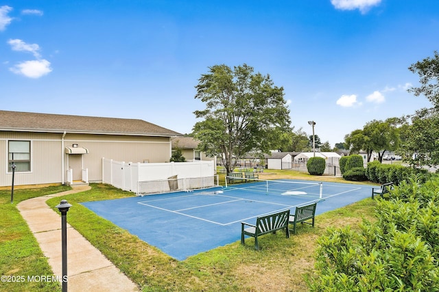 view of tennis court featuring fence