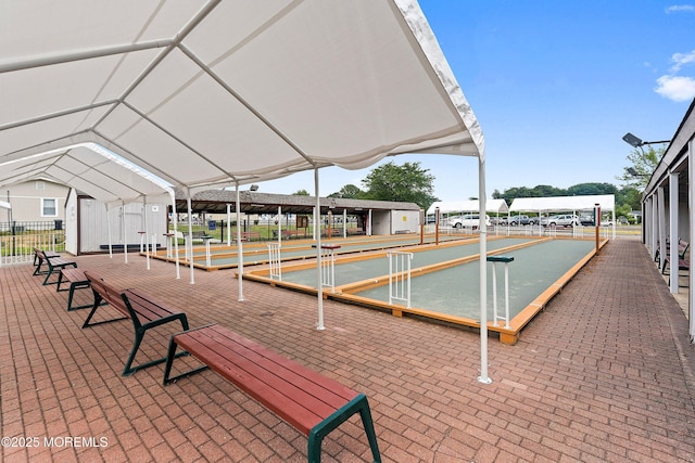 surrounding community featuring a bocce ball area and fence