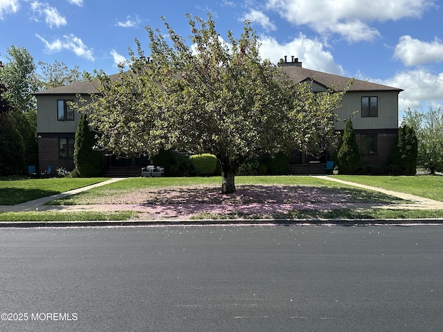 108 Neptune Ave Unit C, Deal, NJ 07723 - obstructed view of property featuring brick siding and a front lawn