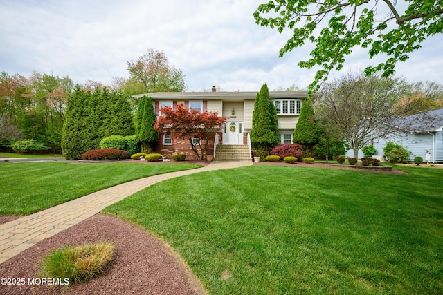 split foyer home with a front yard and a chimney