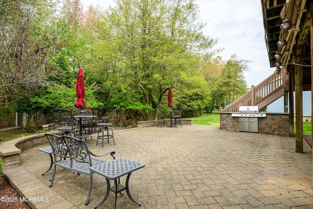view of patio with a grill and outdoor dining space