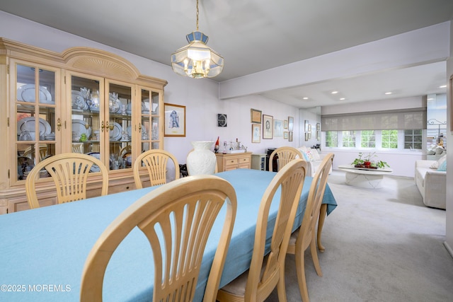 carpeted dining room featuring a chandelier and recessed lighting