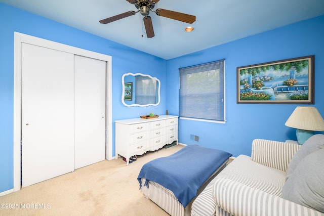 bedroom featuring carpet flooring, a closet, and a ceiling fan