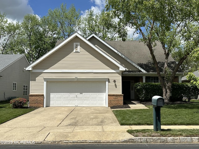 craftsman-style home with brick siding, concrete driveway, a garage, and a front yard