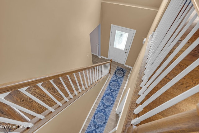 stairs with baseboards and wood finished floors