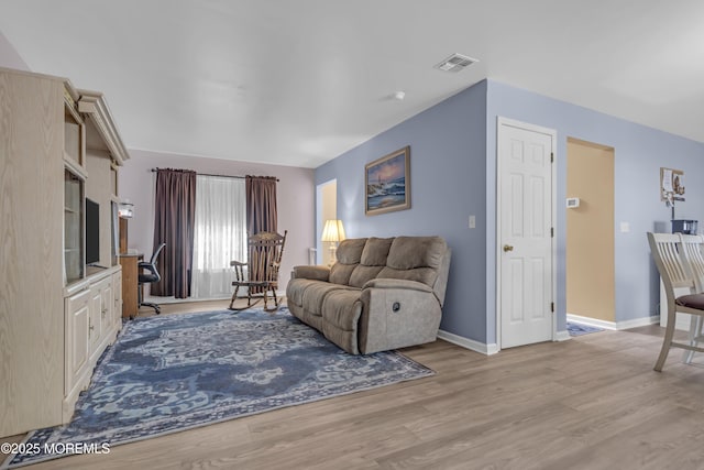 living area with wood finished floors and baseboards