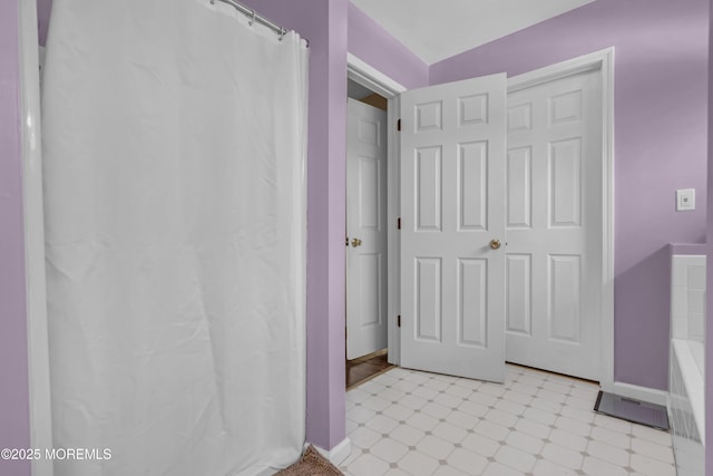 bathroom with tile patterned floors, baseboards, and a shower with curtain