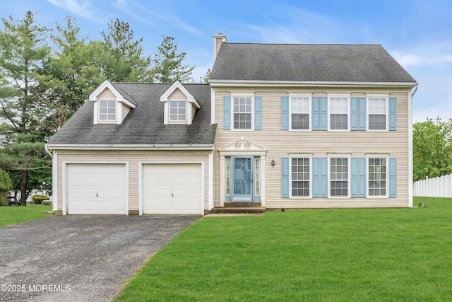 view of front of house featuring a garage, driveway, and a chimney