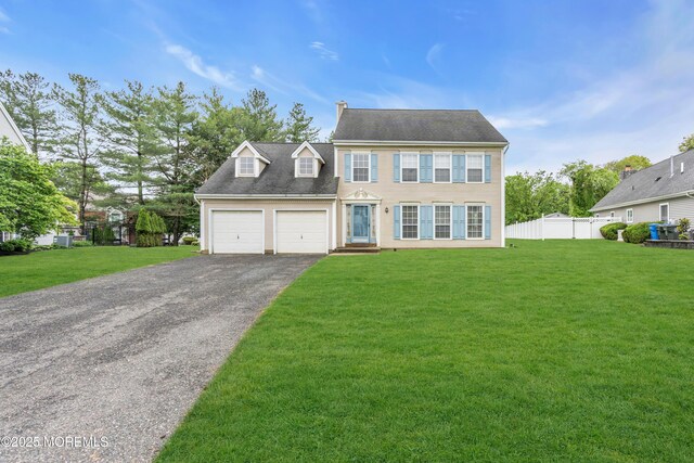 colonial-style house with driveway and an attached garage