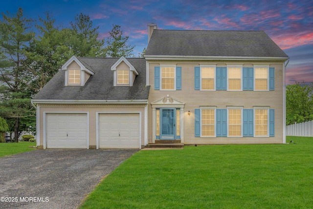 view of front of property featuring a garage, driveway, a chimney, and a shingled roof