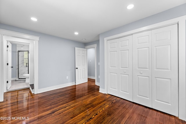 unfurnished bedroom with dark wood-type flooring, baseboards, a closet, recessed lighting, and ensuite bathroom