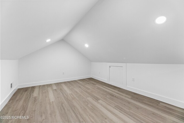bonus room featuring lofted ceiling, wood finished floors, baseboards, and recessed lighting