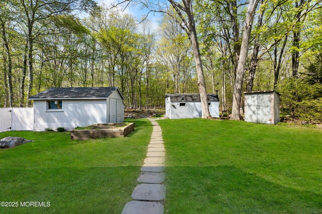 view of yard featuring a storage unit and an outbuilding