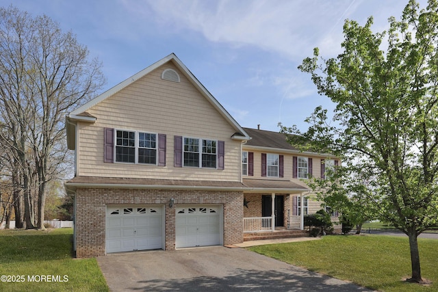 view of front facade with a porch, brick siding, driveway, a garage, and a front yard