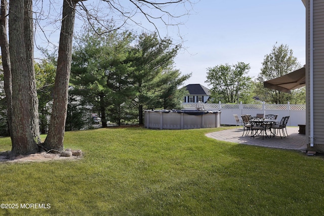 view of yard with fence, a patio, and a fenced in pool